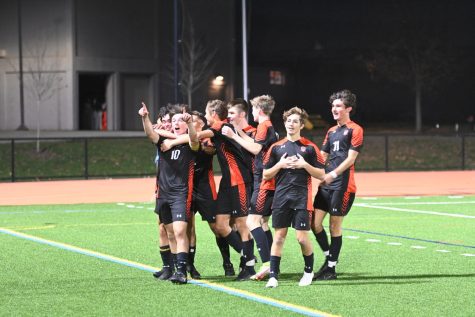 The Wayland boys varsity soccer team celebrates its goal by running to the sidelines and embracing each other. The high intensity game went into overtime after a 2-2 tie, and it ultimately ended in a Wayland Warriors win of 3-2 against Somerville. 