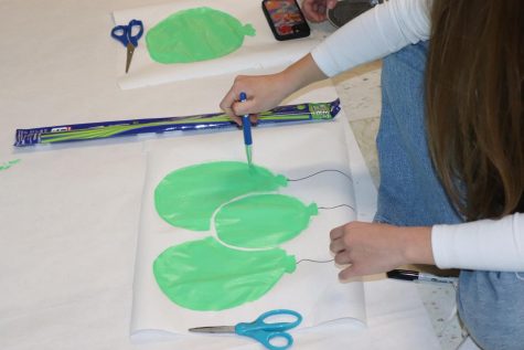 Freshman Audrey Larson paints green balloons. The Wayland High School Student Council provided decorations and supplies for each class. Although students werent able to use balloons as decorations because of latex allergies, the freshmen got creative and painted balloons instead. Bring back balloons, sophomore Micheal Keenan said.