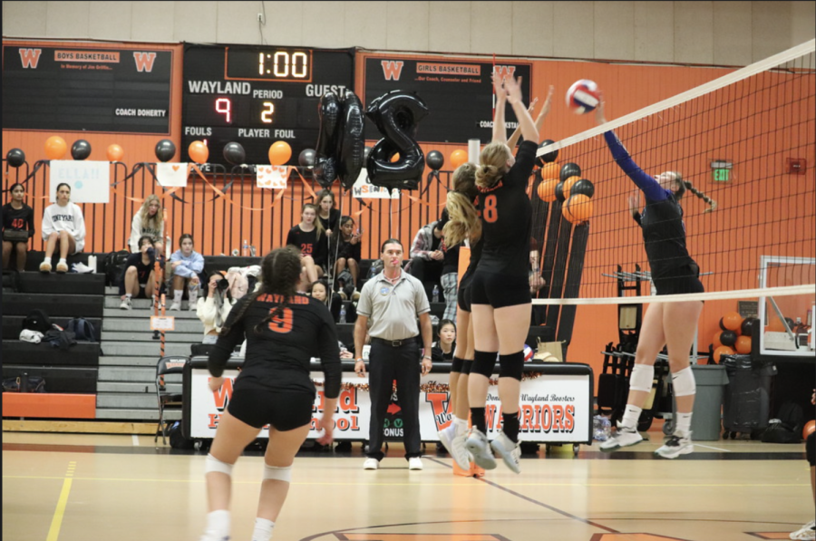Senior captain Ella Zachery and junior Dasha Tveretinova jump up to block the tip that is coming from the opposing side. Senior captain Allie Chase stays close behind them, ready to receive any balls that fall short.