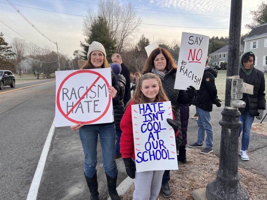WHS senior Marion Hess holds up her hate isnt cool at our school sign. Hesss mother was one of the Wayland community members who organized the rally. “I think it’s important that everyone came [to the rally] because it shows that we’re unified and we won’t stand for something like this,” senior Marion Hess said.