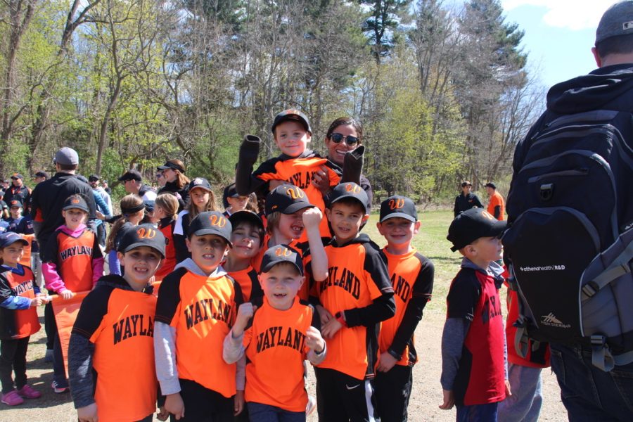 A group of elementary school baseball players stand together at the annual little league parade on Saturday, April 30, 2022. The event featured bouncy houses, face painting, pizza and more for Wayland baseball and softball players of all ages.