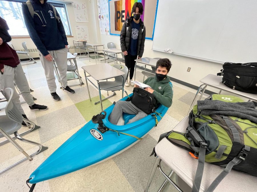 During winter week, students participate in the Anything But a Backpack psyche on Tuesday, Feb. 1, 2022. Students got creative, using cereal boxes, microwaves, supermarket crates and so much more. As pictured, now junior Max Markarian sits in his backpack kayak.