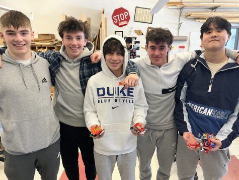 From left to right, seniors Leighton Quinn and Luke Caples, freshman Elliot Kooper-Smith and seniors Leighton Quinn and Kenny Park hold  their candy after winning the challenges.