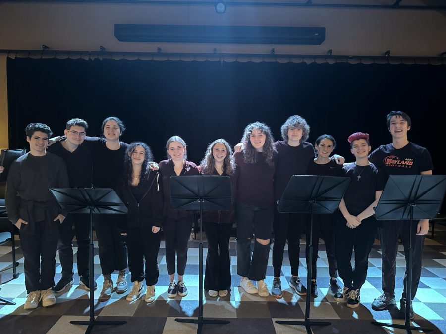 Members of the WHS honors Dramatic Arts class group together before their staged readings. For staged readings, the actors read directly from a script on a music stand instead of memorizing them like in a play.