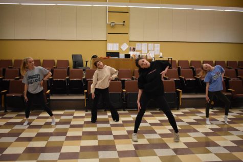 (Left to right) juniors Talia Macchi and Dana Efrat, senior Nina Wilson and freshman Kenzie Macchi move in unison as they practice a jazz number. Window practices in the lecture hall, which is used as a study hall room during the day, and as a meeting space for staff and the Wayland School Committee.