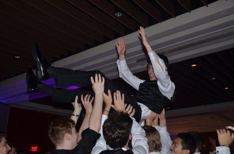 Senior Cal Harding is lifted into the air by his classmates. As the night progressed, more seniors filled the dance floor, celebrating the end of their Wayland high school careers.