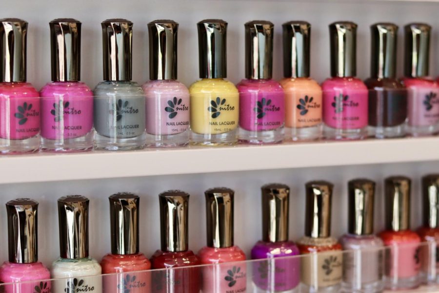 Brightly colored nail polishes are displayed in the front of the salon.