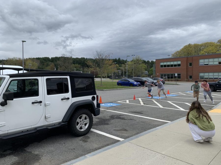 Students run into the car as fast as they can during the Click-It challenge. The Click-It challenge was part of SADDs Safe Driving Week, which was held during the first week of May.