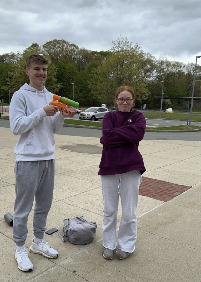 Senior Eric Hiebert shoots senior Serena Fields with his water gun outside of WHS South Building. Students were only able to assassinate each other on school grounds before and after school hours. Furthmore, if a student brought a water gun inside a school building, they would be immediately eliminated. 
