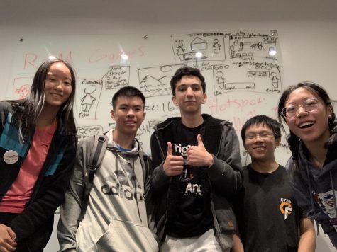  Juniors (left to right) Annabelle Zhang, Raymond Xu, Ari Zuckerman, Justin Cai and Charmaine Guo pose in front of a concept design for their video game they created at the Angel Hacks 3.0 competition. The team won the prize “Most Likely to Cause Players Financial Ruin” at the competition on May 27 and 28. 