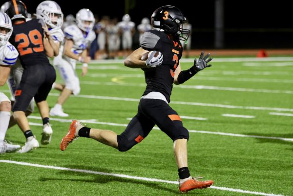 Senior Ben Wright runs down the field while his teammates hold off Ashlands offense. Wright dodged Ashland opponents down the field before being stopped.