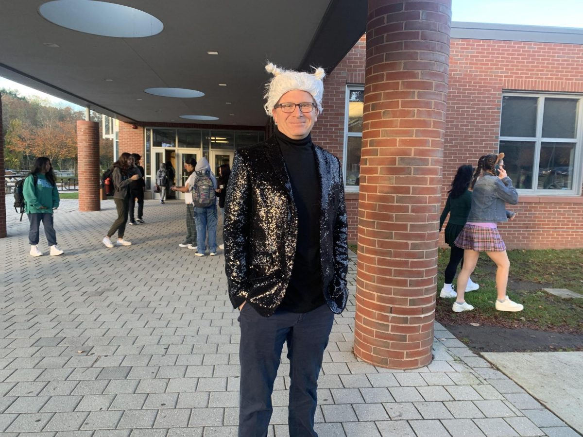 Vice Principal Sean Gass poses in his Mugatu costume as he waits for students to come into school.