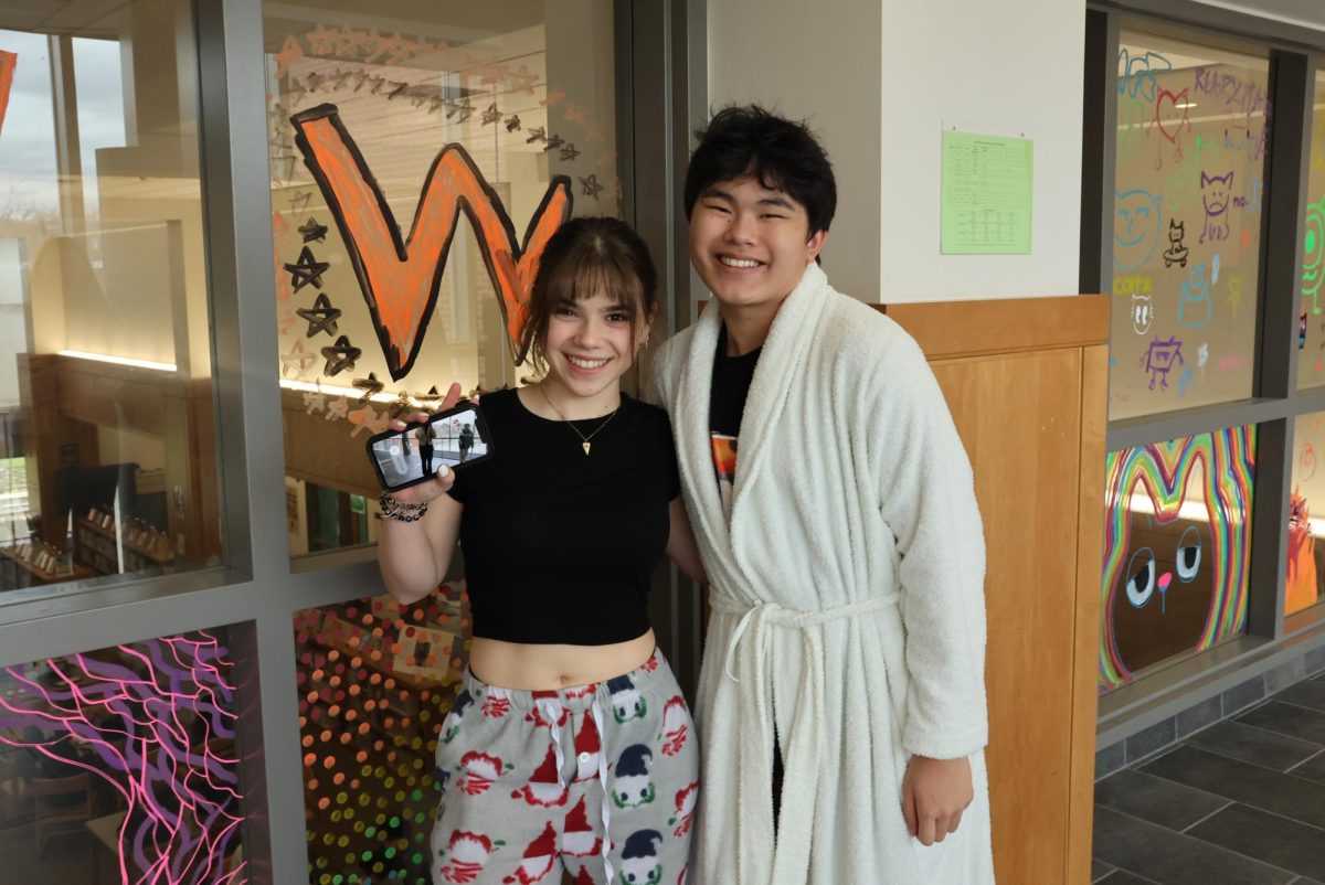 Freshmen Eva Chausse and Alex Tran pose for a photo while dressed in pajamas for Spirit Week.