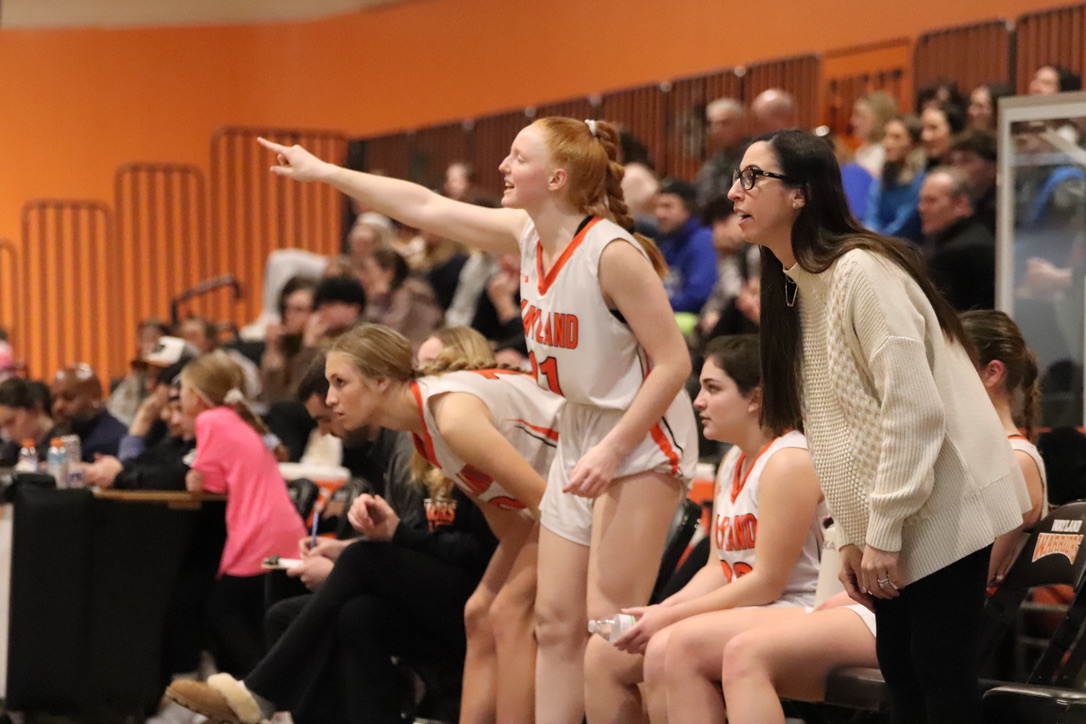 Senior CC Haddad joins her coach Amanda Rukstalis in cheering on the team enthusiatically after halftime. At this time, Bedford was winning 30-17.