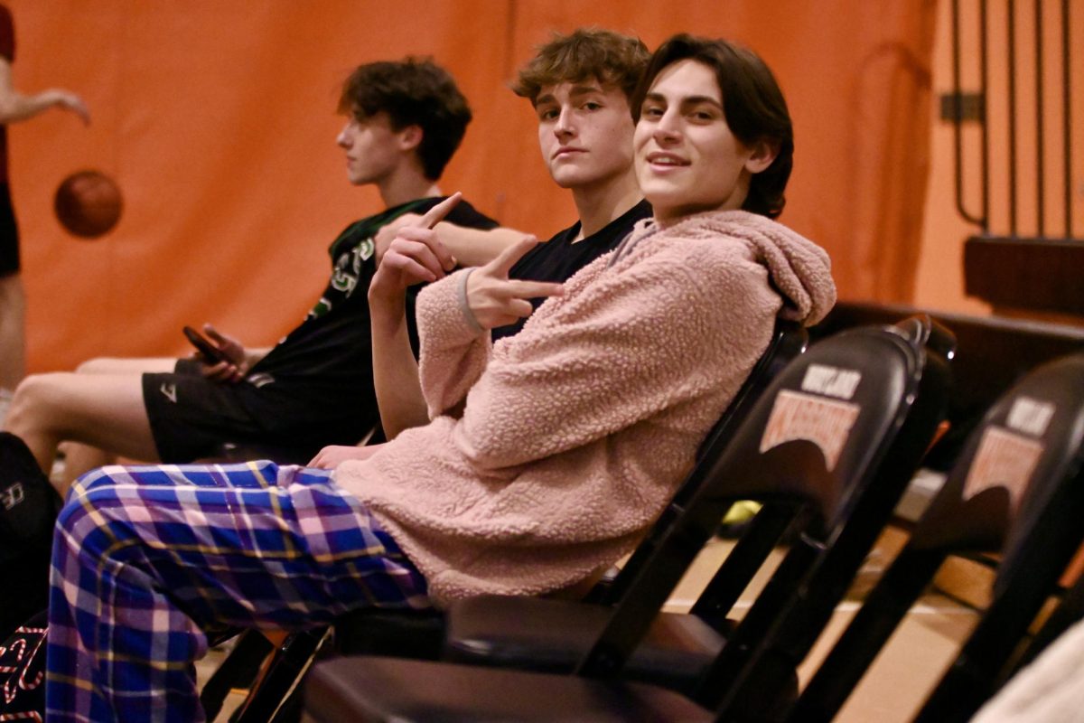 Junior Michael Keenan and senior Giovanni Sebastianelli pose for a photo while watching an Intramural Basketball League (IBL) game.