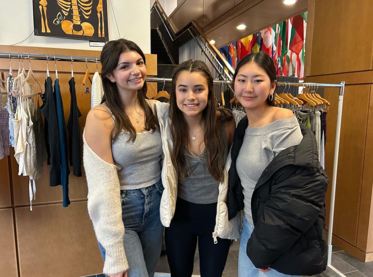 From left to right, juniors and Passion 4 Fashion club leaders Elyssa Grillo, Nina Eyerman and Mischa Lee pose for a photo during the makeshift thrift store event. 