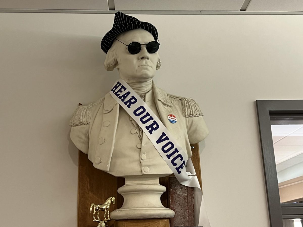 A bust of George Washington watches over the history department office. One of the busts several accessories, sunglasses, fit the criteria for a photo prompt in the scavenger hunt.

Scavenger hunt prompt: put sunglasses on something that shouldn’t be wearing sunglasses.