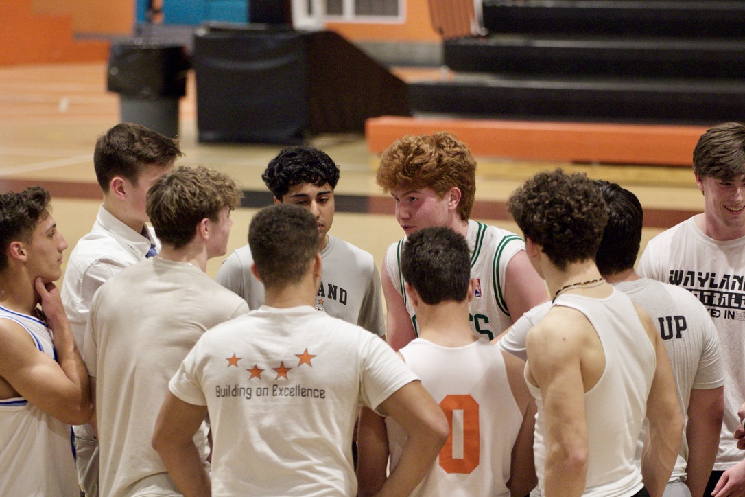 White team captain senior Finn Bumstead talks strategy with his team during a time-out. The white team led the scoreboard early on against the pink team.