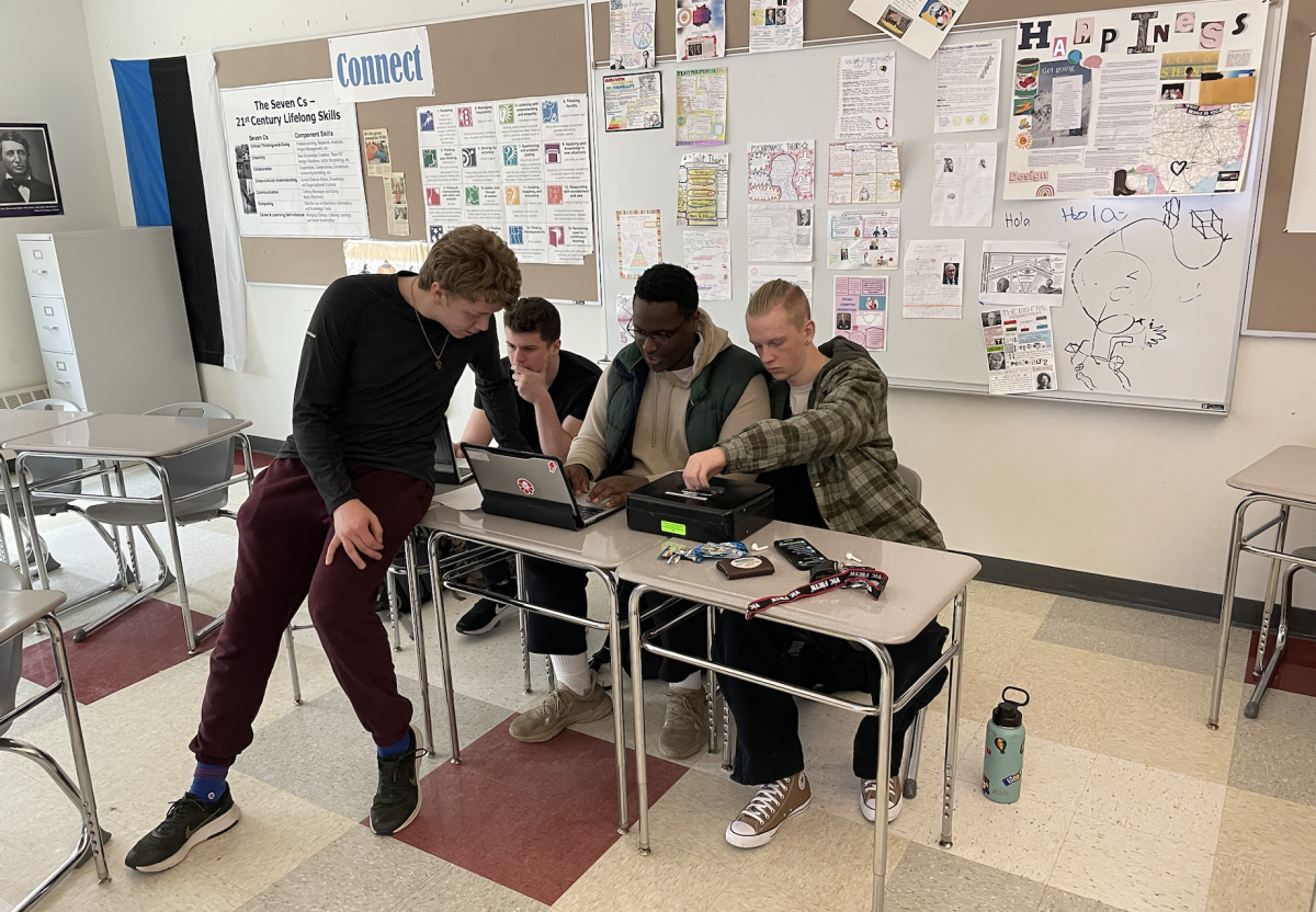 Seniors Garrett Batt, Tom White, Emmanuel Nzaramba and Jack Calverley work together in preparation for the Spring Fling. “We decided to host this because March is kind of a slow month [in which] there’s not really that much happening, so I just thought it would be fun to put pep back into everyone so people could look forward to something this month,” senior Delcie Peter said. 