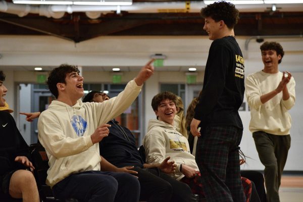 Sophomore Nathan Hartunian points and laughs at junior Jaden Kaufman while playing musical chairs. WHS Field Night took place in the WHS Field House on Thursday, April 11 from 7:30 p.m. until 9 p.m.. 