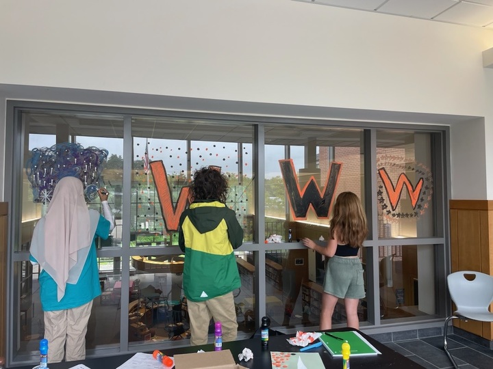 The 2023 to 2024 Summer Bridge Program participants paint the windows overlooking the library as a bonding activity. The Summer Bridge Program and other transition programs are meant to prepare incoming freshmen for the switch from middle school to high school.