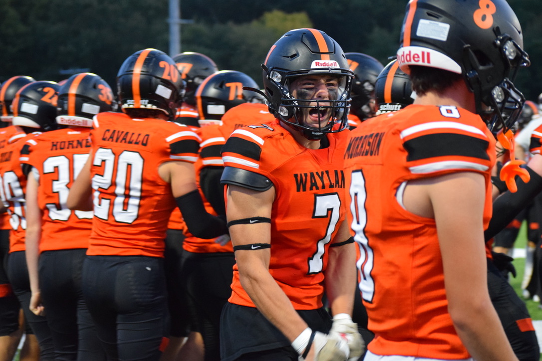 After junior Michael Caulfield takes the ball several yards down the field, senior Jaden Kaufman celebrates with his teammates. Every year, the football team choses a motto to go by during the season. This year's theme is "Brotherhood."