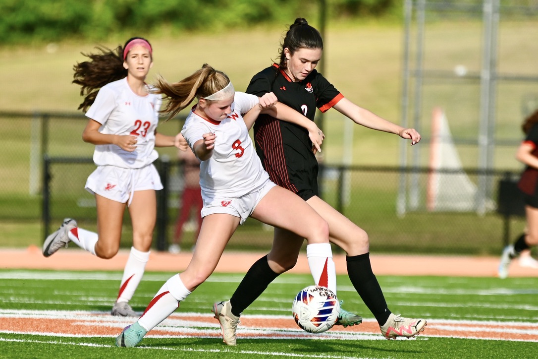 As a Waltham player dribbles the ball, sophomore Natalie O'Neill pressures her. "I thought the game went well and the team had really good communication, and there was a lot of cheering," O'neill said. "Maeve and Avery had some really good goals and I thought everyone worked well together on the field."