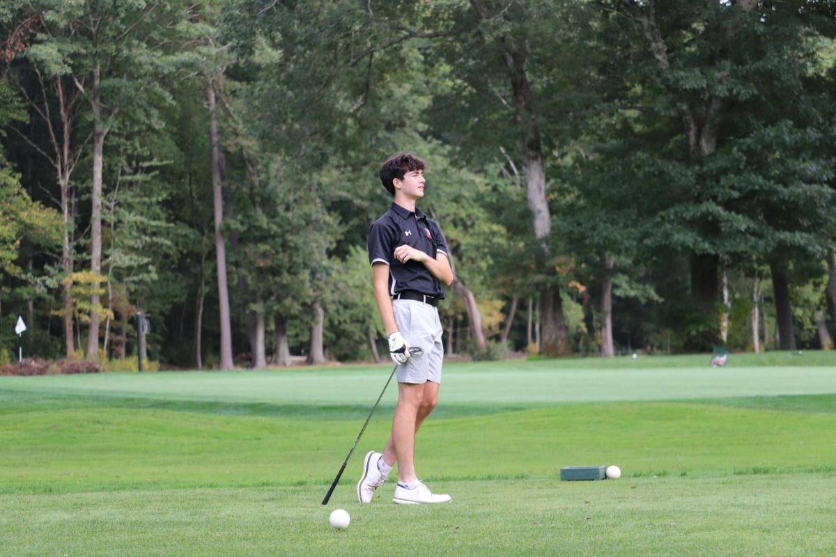 Sophomore Cooper McFarlane watches his ball after hitting his tee shot on the seventh hole. This is McFarlane's first year on the golf team.