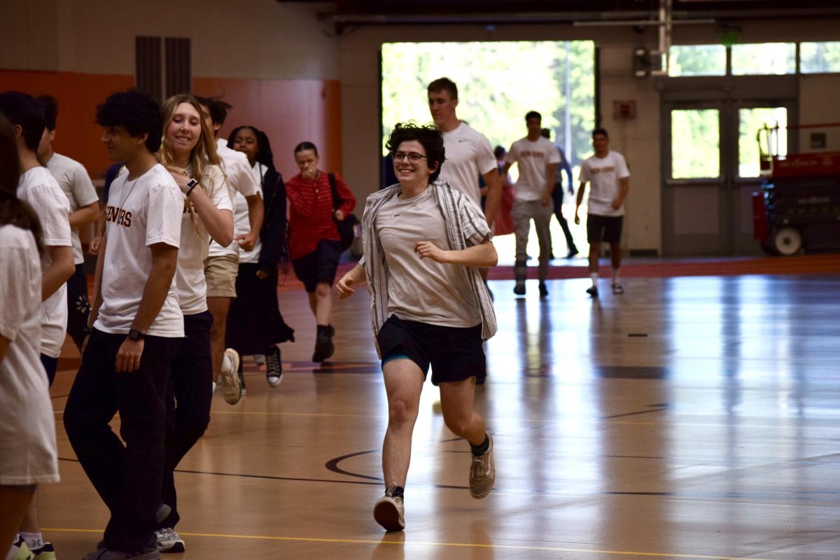 Senior Jack Goode smiles as he runs toward the crowd of seniors. "I was happy to spend the morning with friends," Goode said. "I felt connected to my senior class."