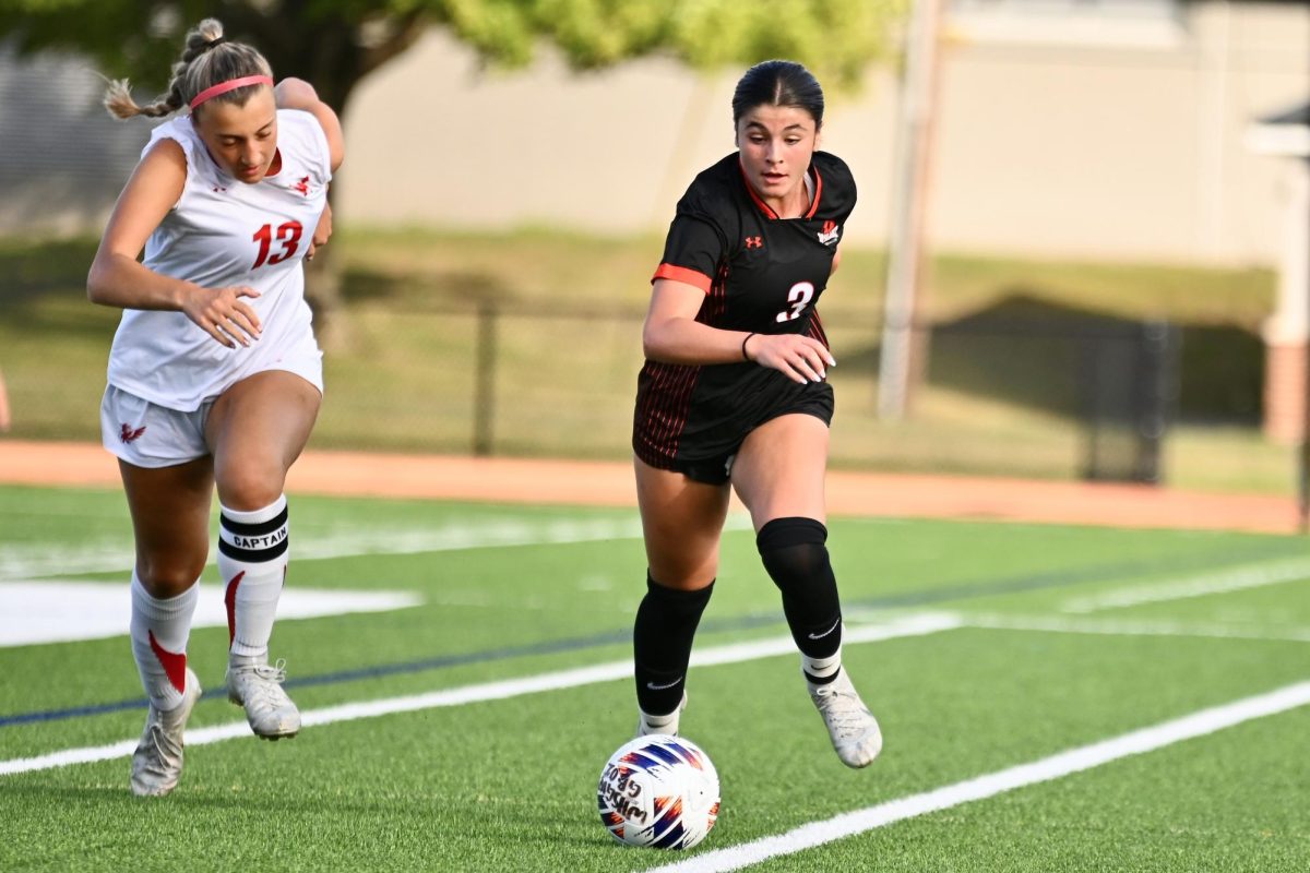 Junior Avery Umina runs after the ball, beating her opponent. Umina plays for FC Stars Elite Clubs National League (ECNL) Regional Blue Team.