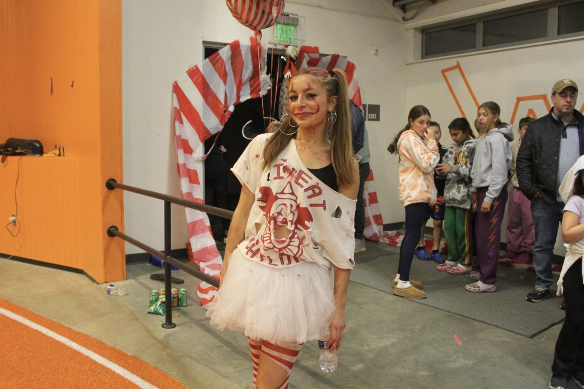 Senior Aidan Shapley takes a break from the haunted house to smile for a photo. Shapley is a member of the Connect Program, and dressed as a clown to scare the attendees.