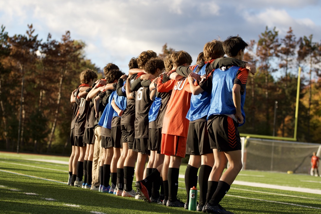 Players on the boys varsity soccer team stand with their arms around each other prior to the kickoff of the second half, proceeding through the rest of the game as one group. "Our group of boys is very close this year, which makes us stronger on the field," sophomore Brady Babineau said. "We treat each other and protect each other like family, which makes us a tough opponent in all aspects."