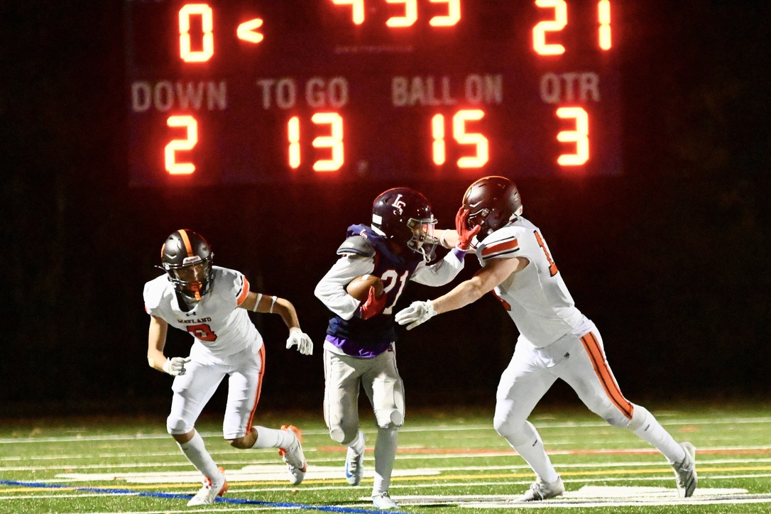 Senior Bowen Morrison (left) and senior captain Owen Finnegan (right) defend a Lincoln-Sudbury player. The varsity football team currently holds a 4-1 record.