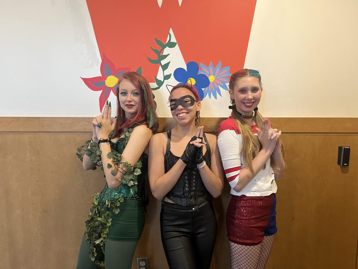 From left to right: seniors Rose Jaquinet, Catalina Caulfield and Cora Cotman-Jenkins strike a pose as Poison Ivy, Cat Woman and Harley Quinn. "I made it myself," Jaquinet said. "I bought the corset, shorts and tights and made my nails and shoes."