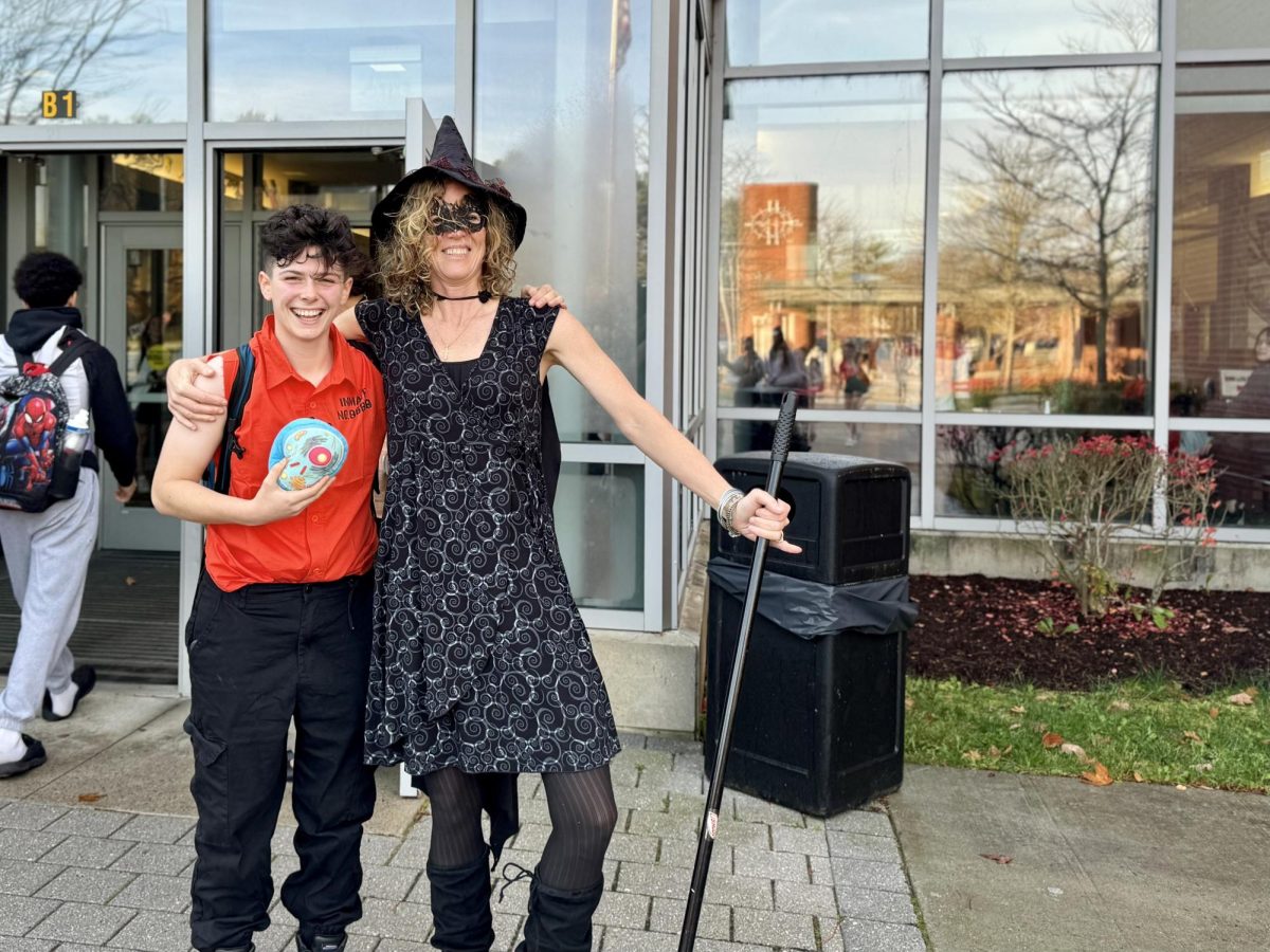 Senior Jack Goode poses with biology teacher Mary Lee York. Goode dressed as "trapped in a cell."