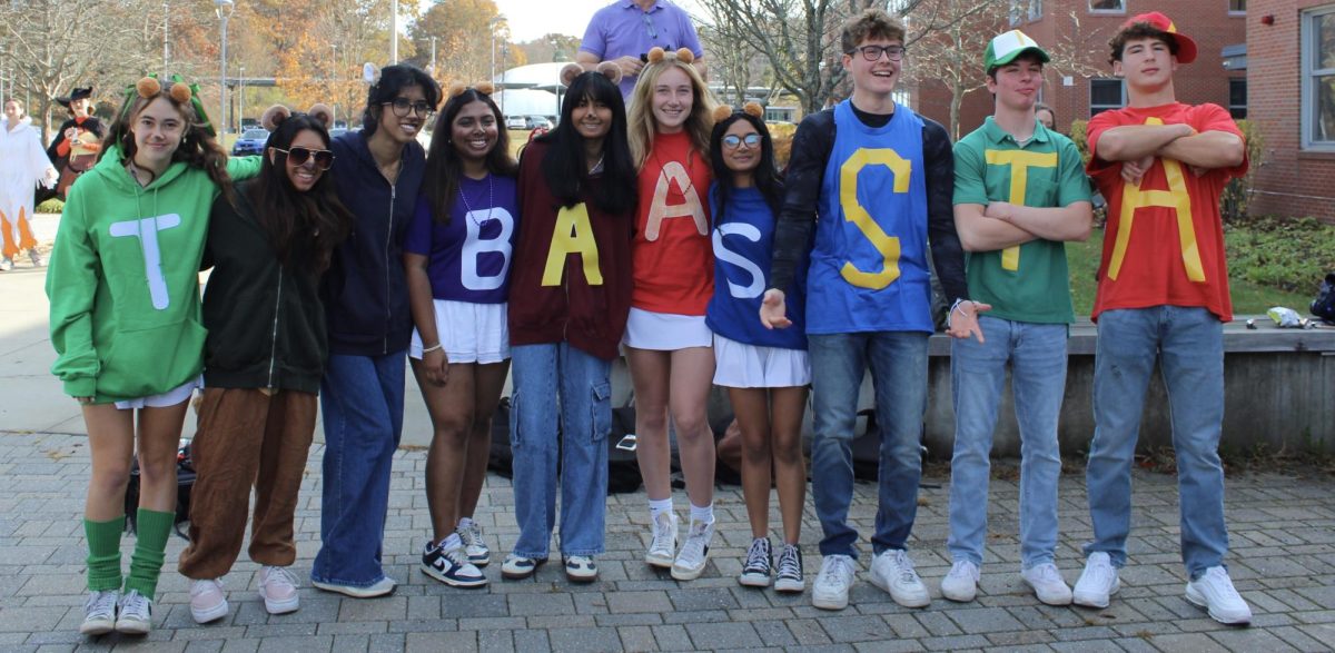 Lining up as chipmunks, (From left to right) seniors Amy Kotzampaltiris Reva Datar, Kanmani Sekhar, Sneha Saju, Tara Sawrikar, Annie McQuilkin, Annika Banglore, Cole Duffy, Paul Lang and Jaden Kaufman, are all dressed up as characters from Alvin and the Chipmunks. During senior Halloween, some groups dressed up with the same costume as other groups. In this photo, the groups had the same idea, but different ways how they executed the costume.