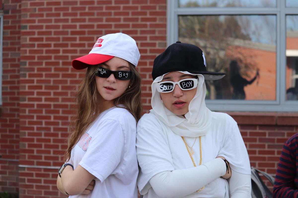 Seniors Marissa D'Amico and Salma Dwidar stand back to back to embody their Soulja Boy inspired costume today in advisory.