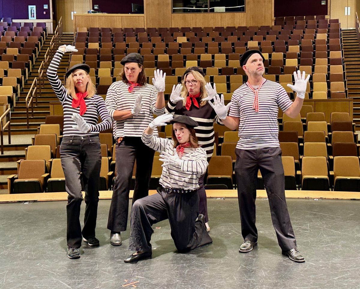 In their element, some of the arts teachers dressed as mimes, posing in the auditorium. Along with seniors, some of the teachers came together to create unique costumes.