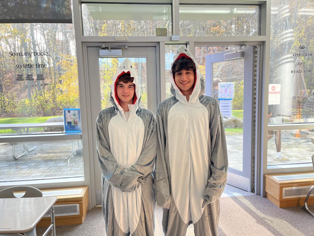 Showcasing their Halloween costumes, seniors Henry Legere and Armaan Chaudhry dress up in matching shark costumes. Some seniors matched their costumes with friends.