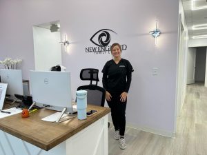 Dr. Erin Civetti poses near the front desk of New England Family Eye. Civetti is an optometrist for a local optometry practice in the Wayland Town Center.