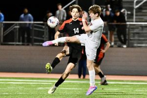 A Marblehead defender crashes into senior captain Lucas Yemin. Yemin plays for the club team Real Boston FC during the off-season.