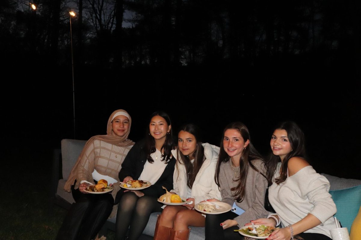 From left to right: seniors Salma Dwidar, Mischa Lee, Nina Eyerman, Jackie Rainville and Elyssa Grillo lounge at the Lappin's house for dinner. "Honestly I loved spending time with people I normally wouldn't spend time with," Dwidar said. "I reflected on the progressing that has been done over the course of my high school career at Wayland."