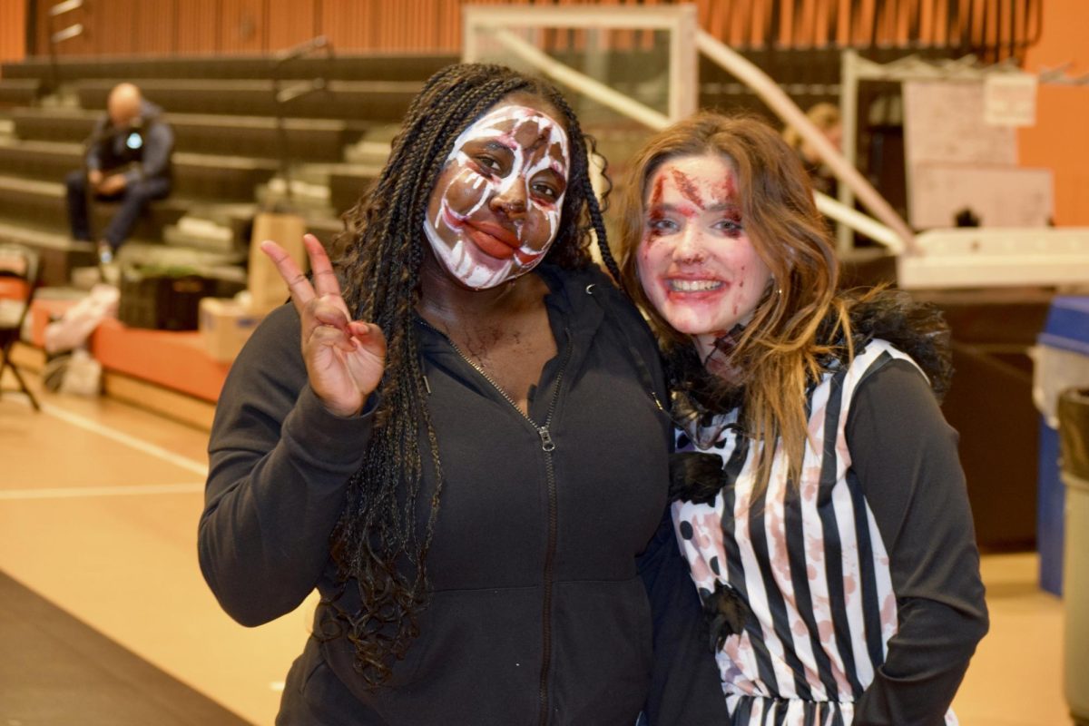 Seniors Kai Drayton and Mackenzie Regan pose. Drayton and Regan are members of the Connect Program. They  worked within the haunted house as "scarers." "I liked seeing the shock on everyone's faces as they came through the haunted house," Drayton said.