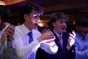 Sophomores Max Berkowitz (left) and Noah Horne (right) clap their hands together as they dance to the music playing.