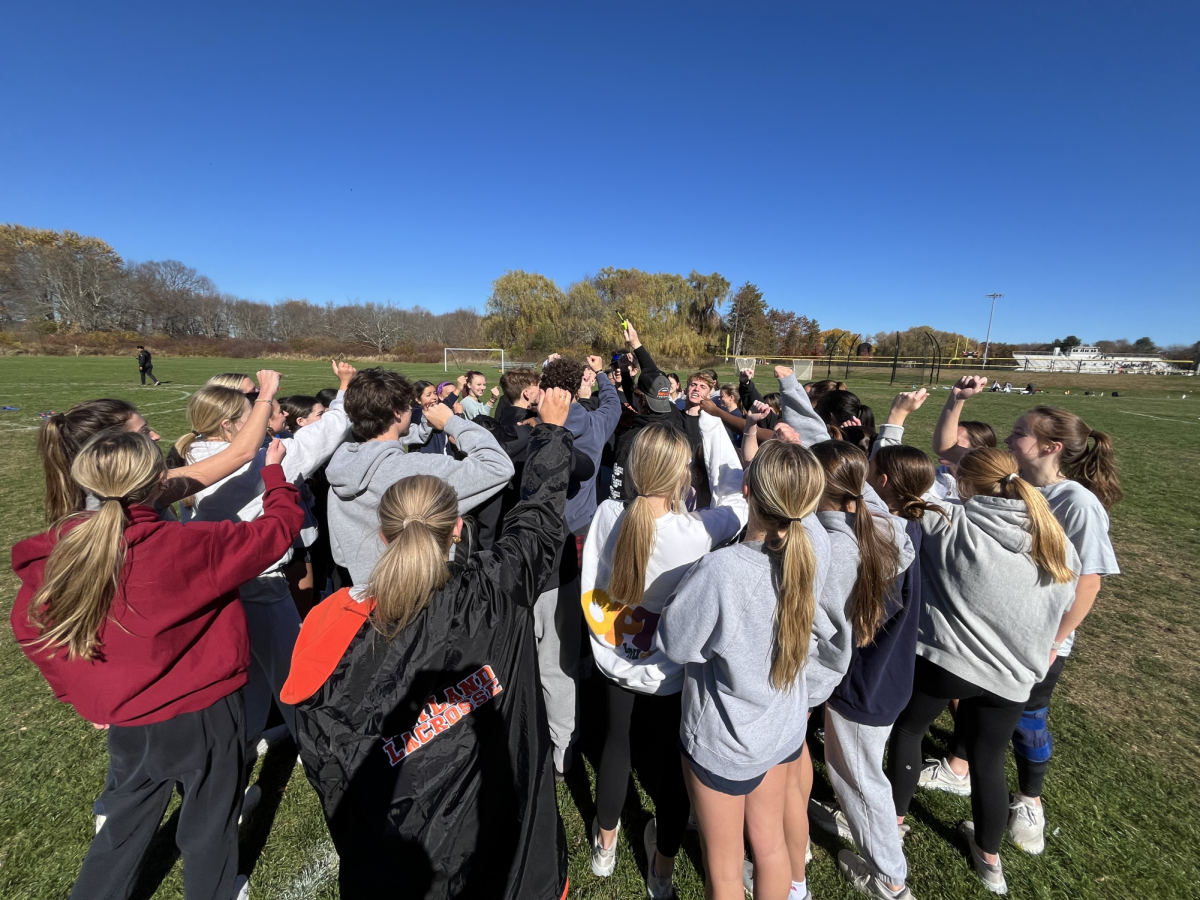 Seniors participating in the powderpuff game gather around in a huddle during a powderpuff practice. "My favorite part about Powderpuff has definitely been how lots of different people have gotten to come together and create memories together while we enjoy the competition," Weston High School senior Anika Groff said.