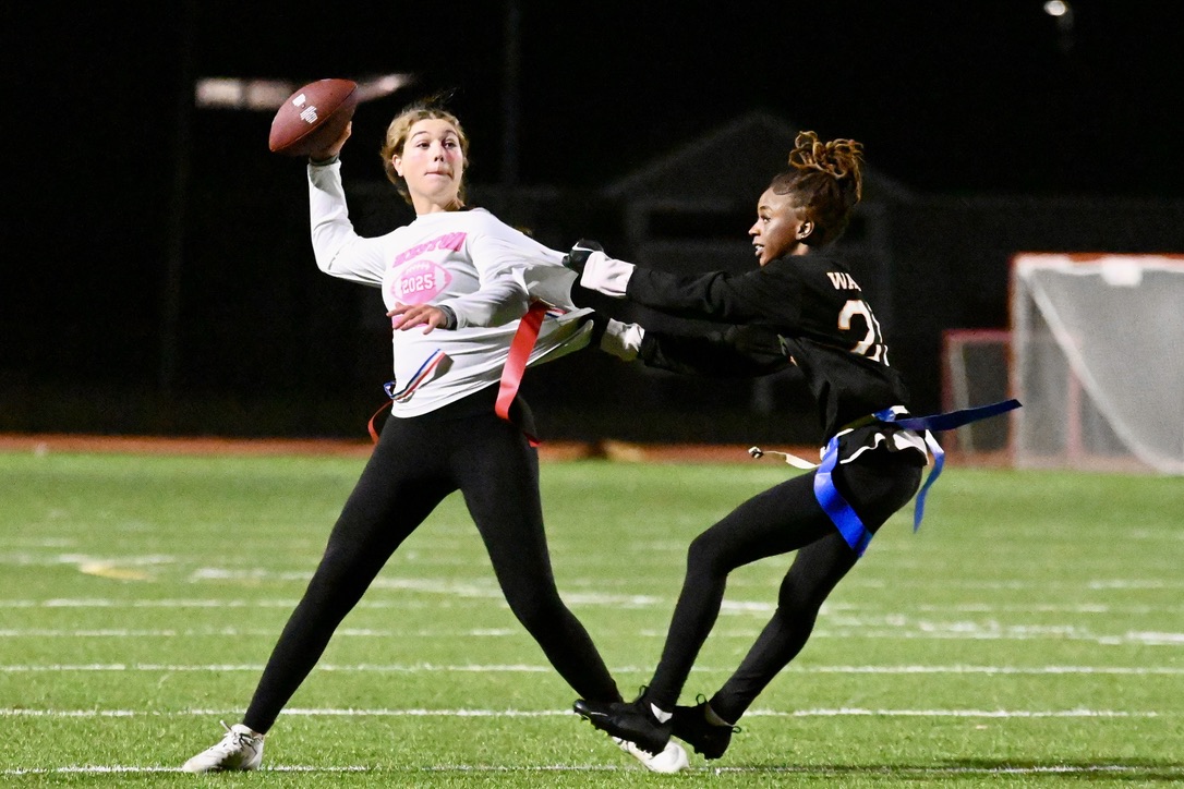 Senior Jahdaya Franklyn tugs off a Weston player's flag as she throws the ball.