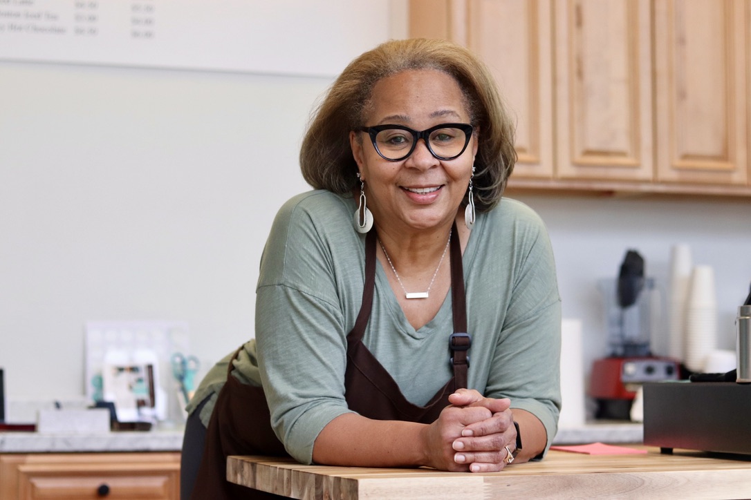 Chocolate Therapy co-owner Pam Griffin smiles at the counter of her chocolate shop, located on 63 Andrew Ave. in the Wayland Town Center. The shop sells a variety of handmade chocolates, coffee, hot chocolate, ice cream and more. Recently, Chocolate Therapy's nut bark was named to "Oprah's Favorite Things 2024 List." The nut bark comes in a box with three flavors: milk chocolate cashew, dark chocolate almond and white chocolate pistachio.