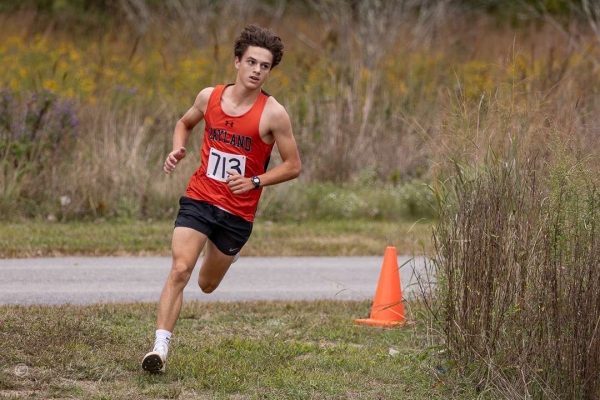 Senior Luke Chisum rounds a corner during his race. Chisum has been on the cross country team since his freshman year and is now committed to Elon University.