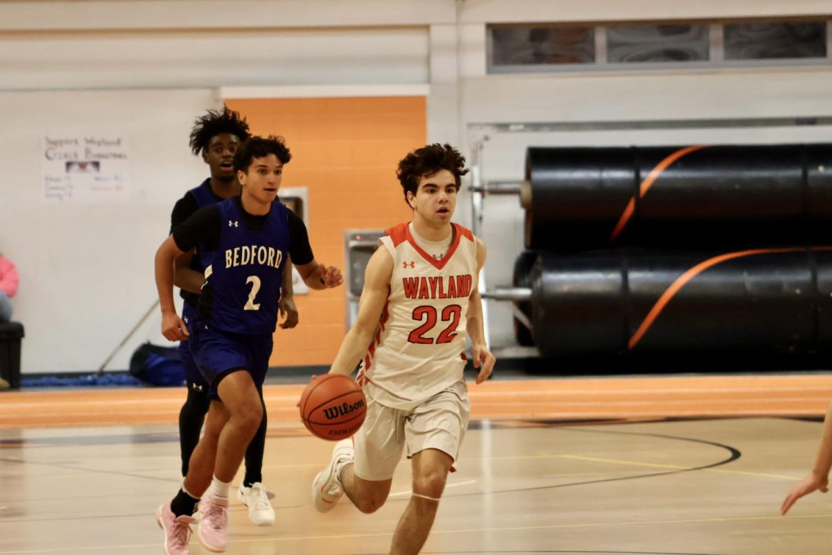 Sophomore Josh Grossman brings the ball up the court after getting a defensive rebound for the Warriors. This is Grossman's first year on varsity.