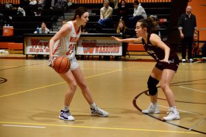 As a Westford player defends, freshman Campbell Powers looks for a way to dodge them. The girls varsity basketball head coach Steven Marks runs an Instagram account "waylandgbball," where he announces the upcoming games, final scores and player of the game. The "player of the game" against Westford was sophomore Patara Tezduyar.